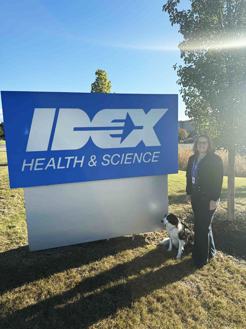 Danielle and Cooper by the IDEX Health & Science Sign