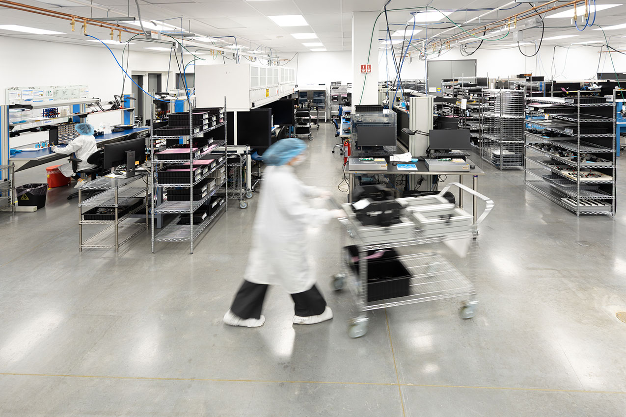 technician moving product in the manufacturing floor
