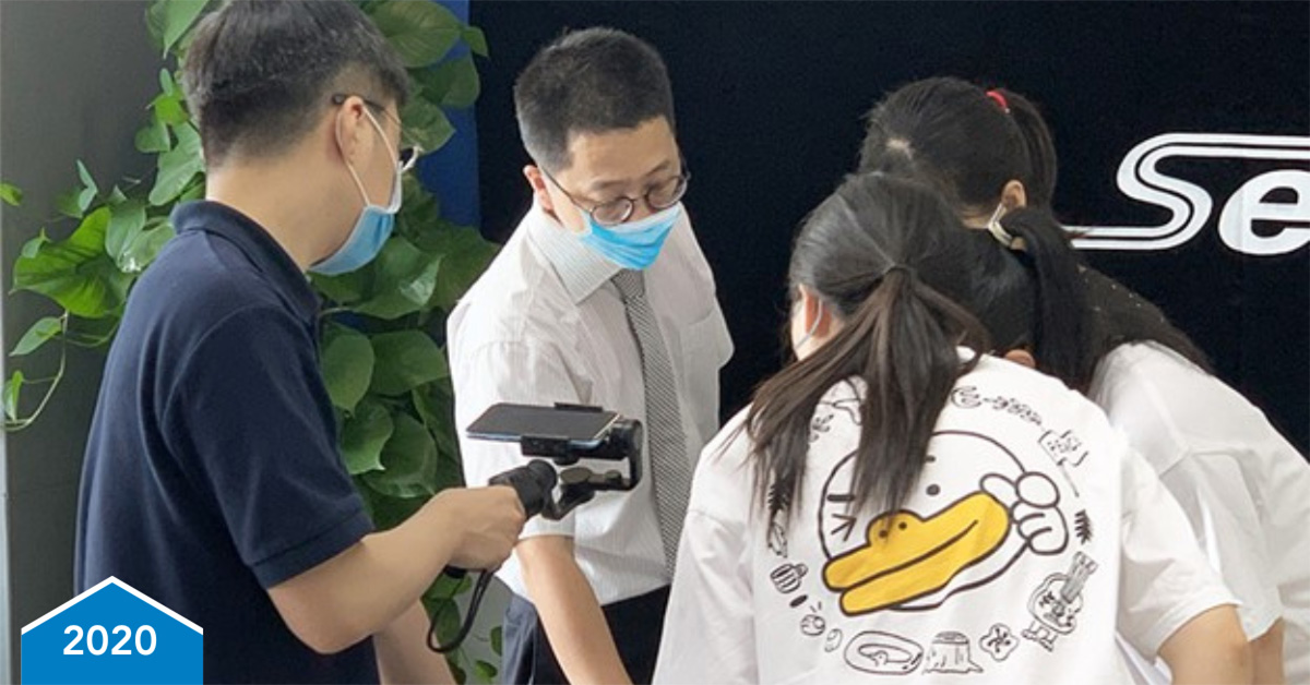 student and teacher studying optical filter laying on a table